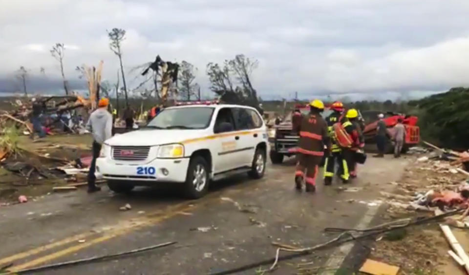 Emergency responders work in the scene amid debris in Lee County, Ala., after what appeared to be a tornado struck in the area, March 3, 2019. Severe storms destroyed mobile homes, snapped trees and left a trail of destruction amid weather warnings extending into Georgia, Florida and South Carolina, authorities said. (Photo: WKRG-TV via AP)