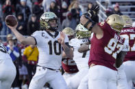 Wake Forest quarterback Sam Hartman (10) passes under pressure from Boston College defensive end Marcus Valdez (97) during the first half of an NCAA college football game, Saturday, Nov. 27, 2021, in Boston. (AP Photo/Mary Schwalm)