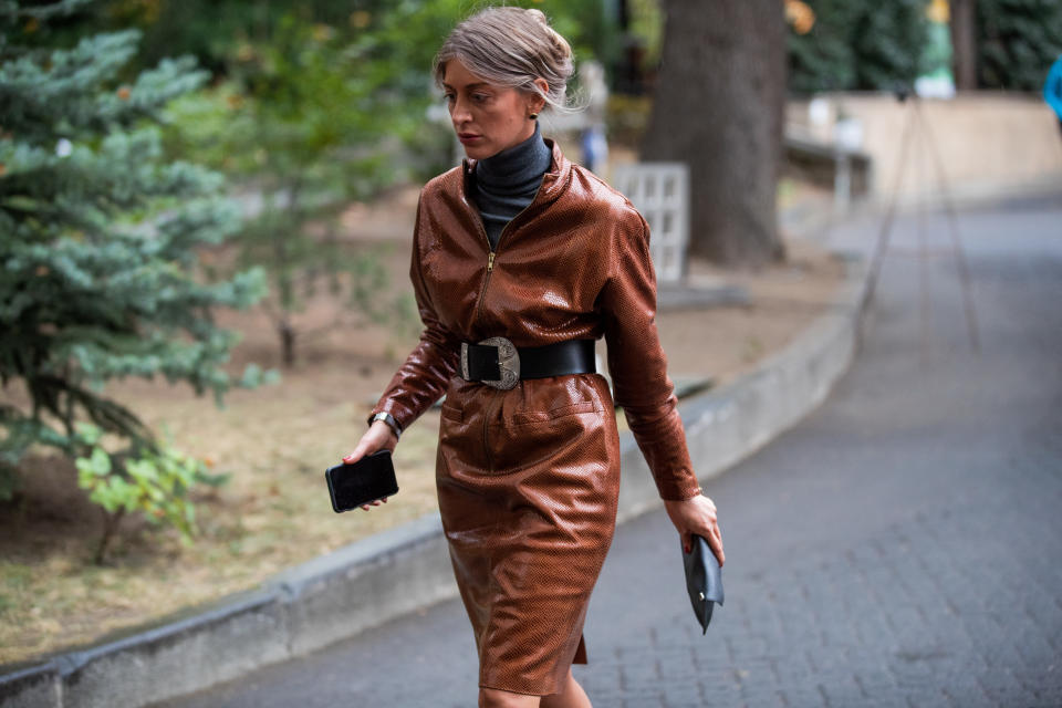 TBILISI, GEORGIA - OCTOBER 31: A guest is seen wearing brown belted coat during day 1 of the Mercedes-Benz Tbilisi Fashion Week on October 31, 2019 in Tbilisi, Georgia. (Photo by Christian Vierig/Getty Images)