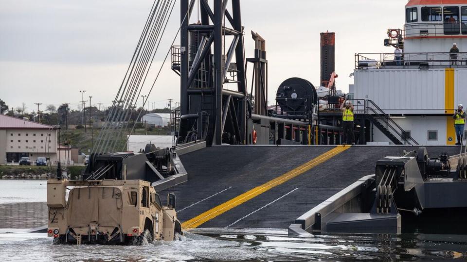 A joint light tactical vehicle drives onto the stern landing vessel at the Del mar Boat Basin at Camp Pendleton, Calfornia, during Project Convergence Capstone 4. (Lance Cpl. Mhecaela Watts/Marine Corps)