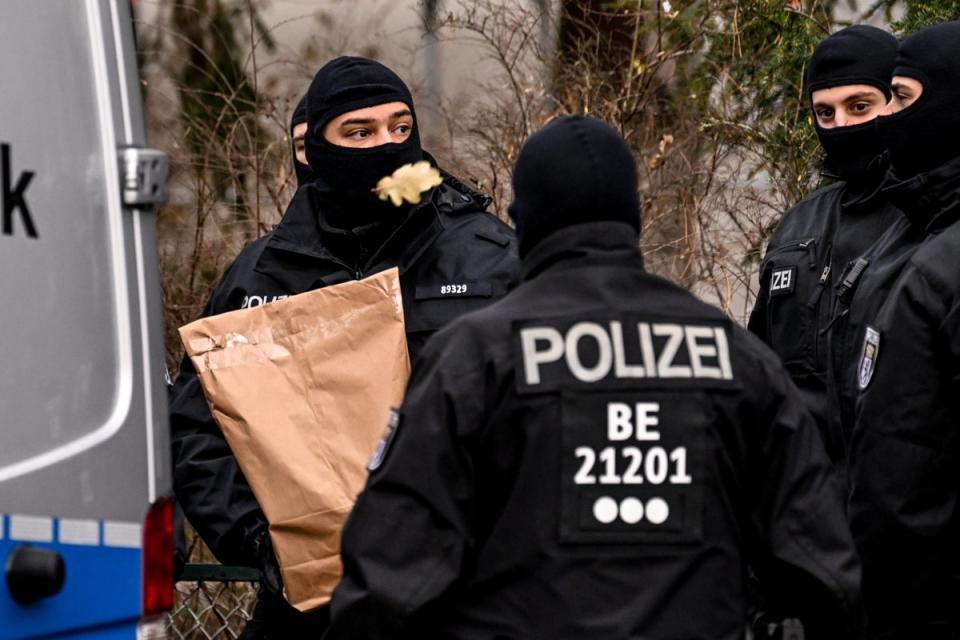 Police officers work during a raid in Berlin (EPA)