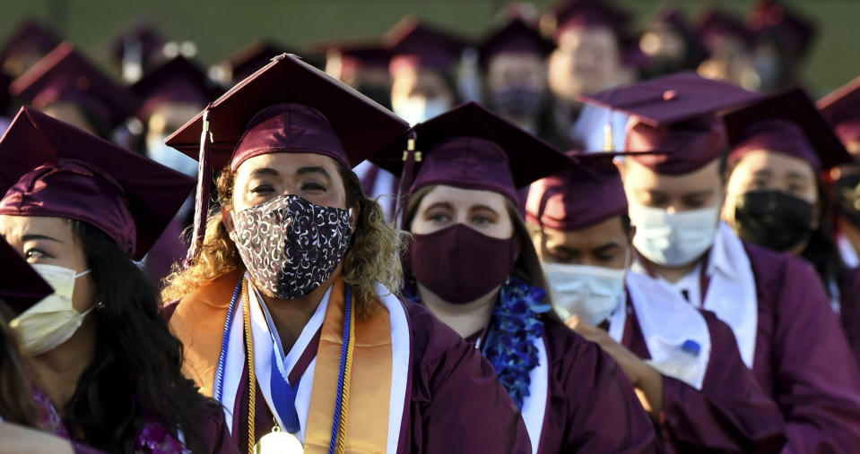 Students wearing masks listen to speakers during the Mount Sac graduation at Hilmer Lodge Stadium in Walnut, Calif., Friday, June 11, 2021. (Keith Birmingham/The Orange County Register via AP)