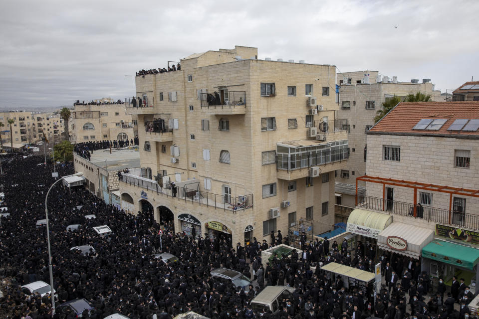 Thousands of ultra-Orthodox Jews participate in the funeral of prominent rabbi Meshulam Soloveitchik, flouting the country’s ban on large public gatherings amid the pandemic, in Jerusalem, Sunday, Jan. 31, 2021. The mass ceremony took place despite the country's health regulations banning large public gatherings, during a nationwide lockdown to curb the spread of the virus. (AP Photo/Ariel Schalit)