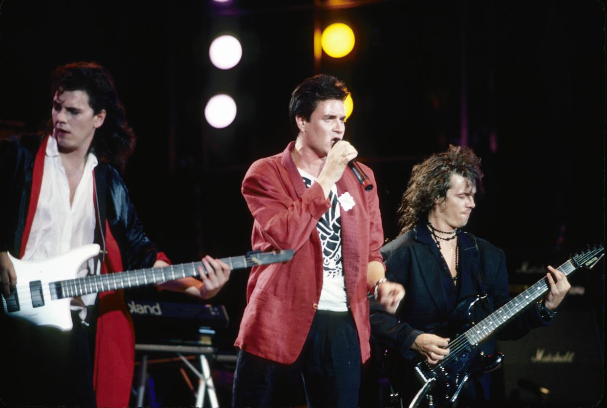 (MANDATORY CREDIT Ebet Roberts/Getty Images) UNITED STATES - JULY 13:  Photo of LIVE AID and DURAN DURAN; John Taylor, Simon Le Bon, Andy Taylor, performing live onstage at Live Aid  (Photo by Ebet Roberts/Redferns)