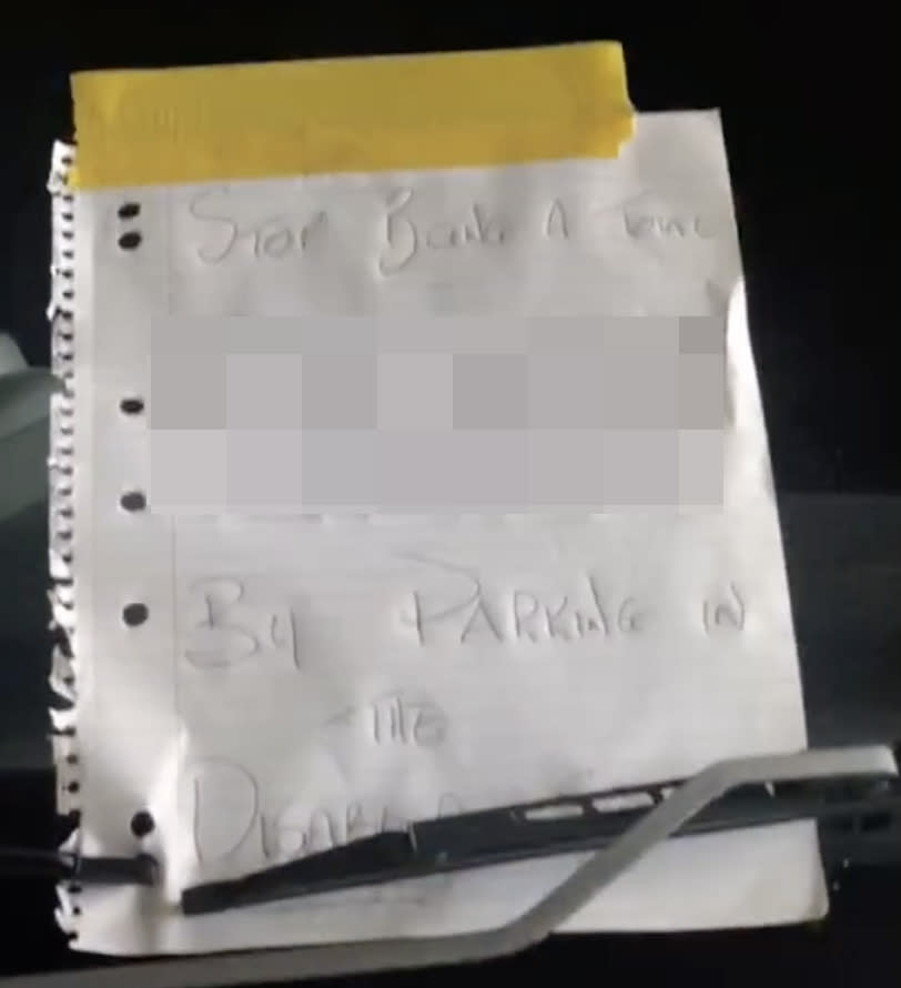 A note on a car parked outside of Waterloo Hotel in Brisbane asks the driver crudely not to park in the disabled bay.