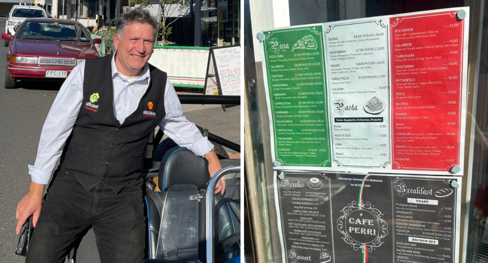 Jimmy Perry, owner of Café Perry, stands next to the cafe's menu.