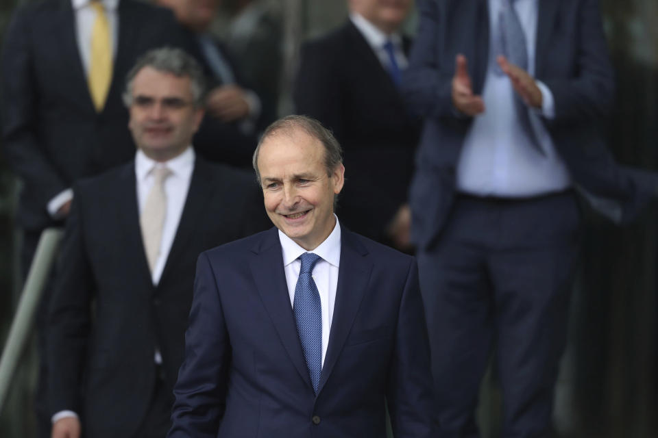 Fianna Fail party leader Micheal Martin leaves the Dail government in Dublin, where he has been officially elected as the new Irish Premier, Saturday June 27, 2020. As part of a pact between Martin and former premier Varadkar, Martin will take the role of Premier until December 2021, with Mr Varadkar resuming the role for the remainder of the Government term of office. (Niall Carson/PA via AP)