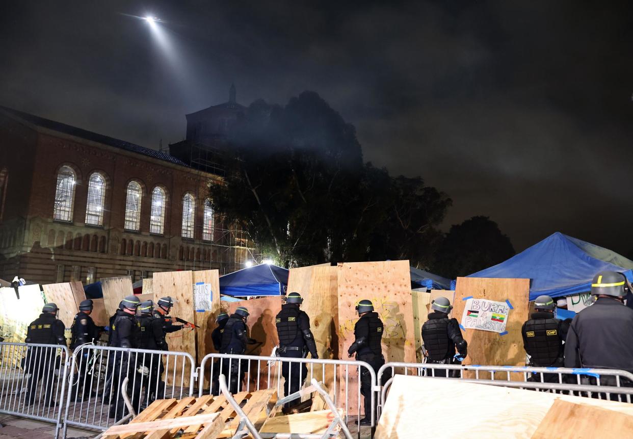 <span>Clashes … officers clear a pro-Palestinian encampment at the University of California, Los Angeles, campus.</span><span>Photograph: Mario Tama/Getty Images</span>