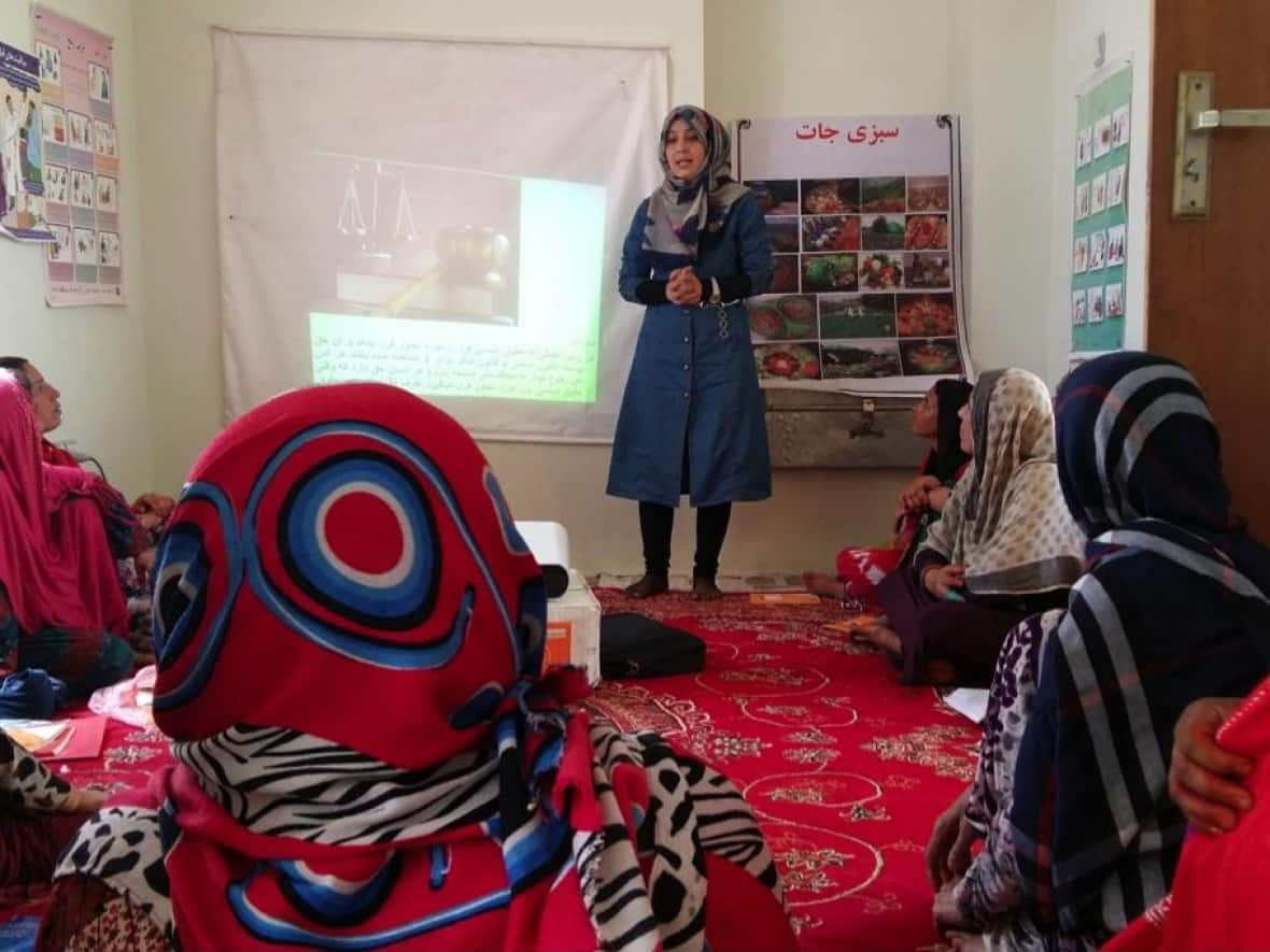 Defence lawyer Nelofar Akbari is pictured speaking about women's rights in Afghanistan before she fled the country on Oct. 23. She is one of thousands of refugee applicants hoping to be admitted into Canada. (Submitted by Nelofar Akbari - image credit)