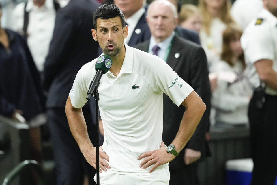 Novak Djokovic of Serbia reacts as he is interviewed after defeating Holger Rune of Denmark in their fourth round match at the Wimbledon tennis championships in London, Monday, July 8, 2024. (AP Photo/Mosa'ab Elshamy)
