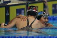 Torri Huske hugs Kelsi Dahlia after winning the Women's 100 Butterfly during wave 2 of the U.S. Olympic Swim Trials on Monday, June 14, 2021, in Omaha, Neb. (AP Photo/Jeff Roberson)