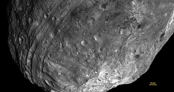 Vesta used to be round—until it got hit by something nearly one-tenth its size. The resulting impact basin, named Rheasilvia, fills most of this image, taken from some 5,200 kilometers away. Vesta’s south pole lies in the mountains at lower rig