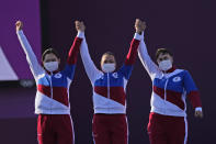 From left, second placed Svetlana Gomboleva, Elena Osipova, and Ksenia Perova, of the Russian Olympic Committee celebrate on the podium of the women's team competition at the 2020 Summer Olympics, Sunday, July 25, 2021, in Tokyo, Japan. (AP Photo/Alessandra Tarantino)