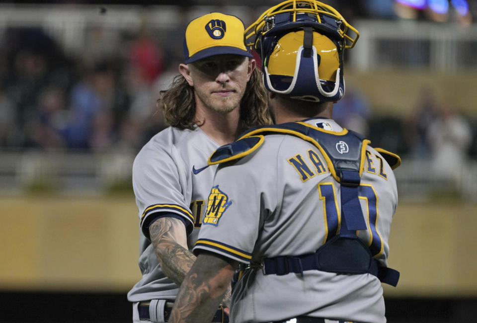 Milwaukee Brewers relief pitcher Josh Hader, left, and catcher Omar Narvaez celebrate after the Brewers defeated the Minnesota Twins in a baseball game Tuesday, July 12, 2022, in Minneapolis. Hader picked up the save. (AP Photo/Jim Mone)