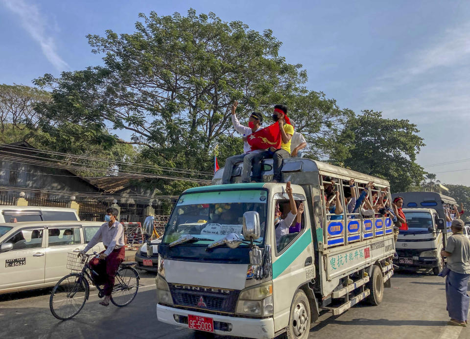 Demonstrators flash three-fingered salute, a symbol of resistance against the military coup in Yangon, Myanmar Thursday, Feb. 12, 2021. Large crowds demonstrating against the military takeover in Myanmar again defied a ban on protests, even after security forces ratcheted up the use of force against them. (AP Photo)