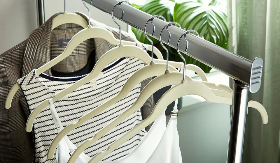 ivory-colored velvet hangers holding clothes