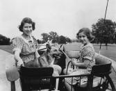 <p>Princess Elizabeth and Princess Anne play with one of the family's corgis.</p>