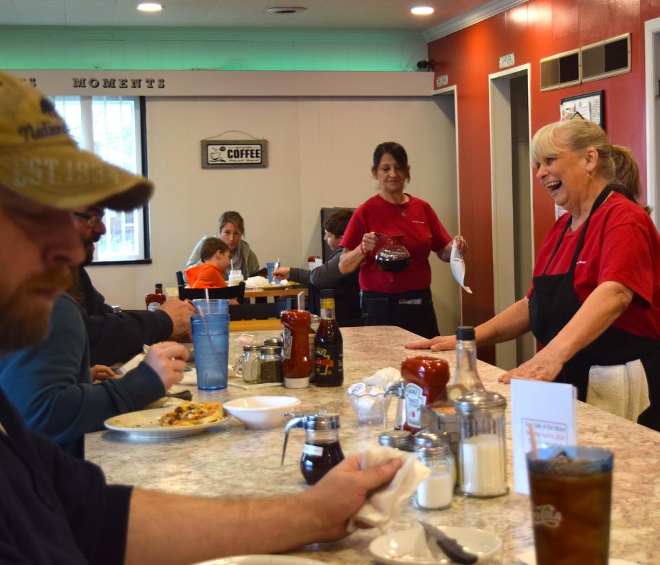 Bonnie "Maw Maw" Crider visits with diners at the counter of her restaurant, Maw Maw's, at the corner of state Routes 39 and 60 west of Millersburg.
