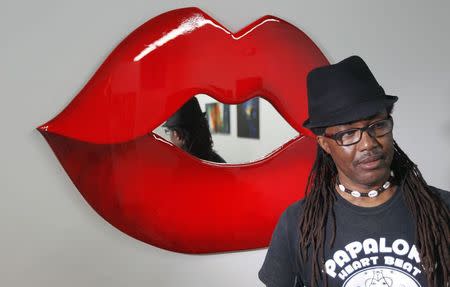 Jude Papaloko poses in front of one of his art pieces in his gallery in the Miami neighborhood of Wynwood October 6, 2014. REUTERS/Andrew Innerarity