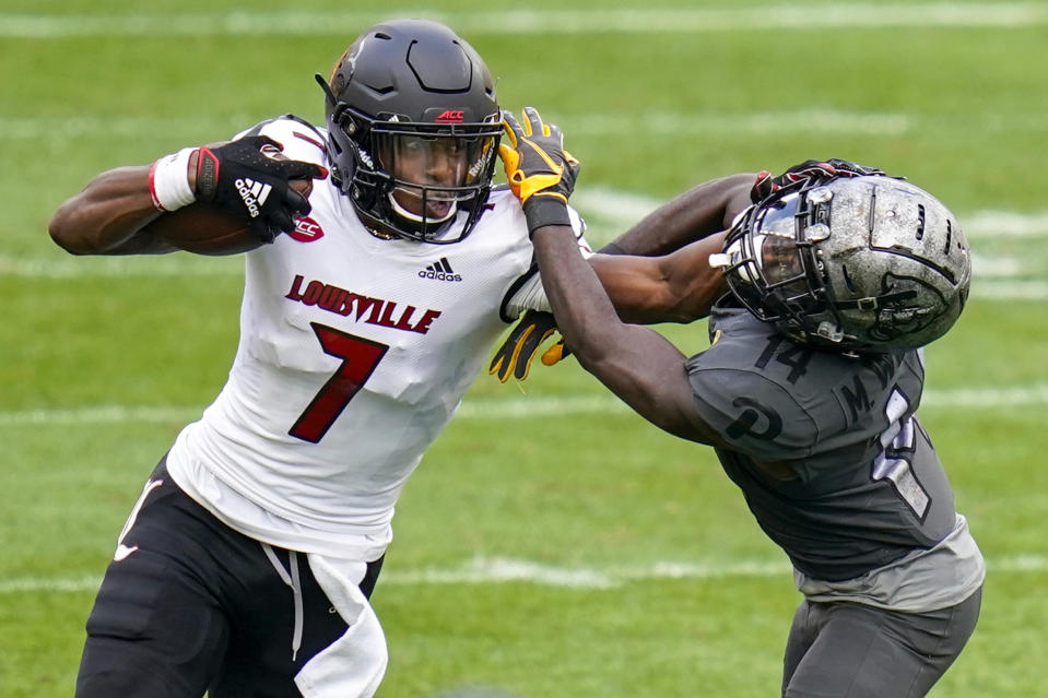 Louisville wide receiver Dez Fitzpatrick (7) stiff-arms Pittsburgh defensive back Marquis Williams (14) as he tries for more yards after a catch during the second half of an NCAA college football game, Saturday, Sept. 26, 2020, in Pittsburgh. Pittsburgh won 23-20. (AP Photo/Keith Srakocic)