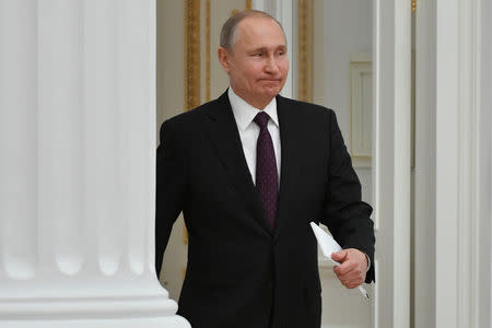 FILE PHOTO: Russian President Vladimir Putin enters a hall to meet French business leaders at the Kremlin in Moscow, Russia April 18, 2019. Alexander Nemenov/Pool via REUTERS