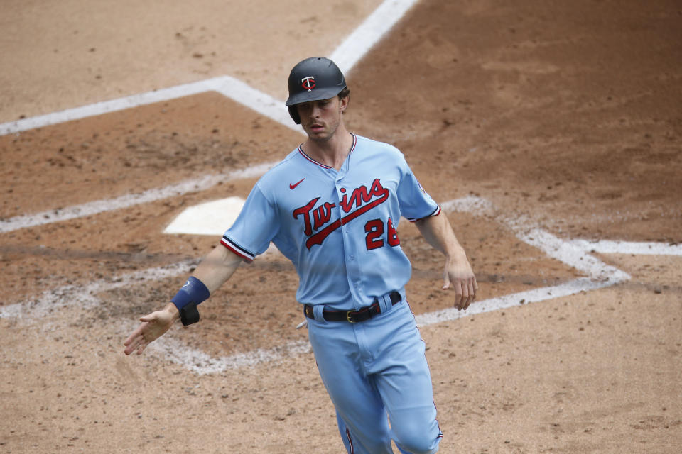 Minnesota Twins' Max Kepler scores from second base on a single by Nelson Cruz in the third inning of a baseball game against the Cleveland Indians Sunday, Aug. 2, 2020, in Minneapolis. (AP Photo/Jim Mone)