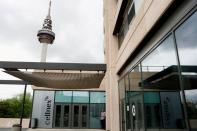 FILE PHOTO: A man smokes outside the offices of Spain's telecom infrastructure company Cellnex in Madrid