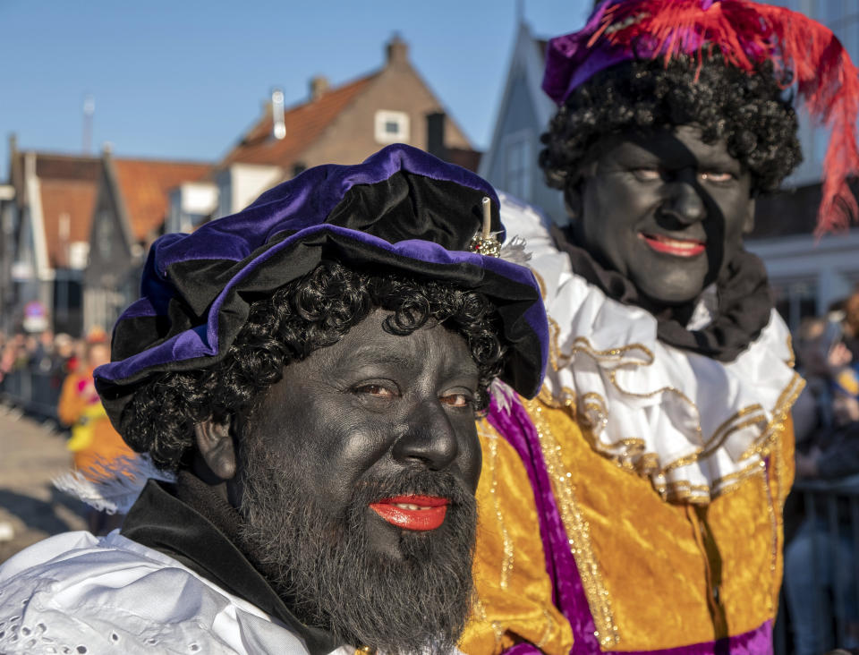 FILE - In this Nov. 17, 2018, file photo, participants in the arrival of Sinterklaas, a legendary figure based on Saint Nicholas, in Monnickendam, Netherlands, dress up as Black Pete during an annual festival. The scandal surrounding Canadian Prime Minister Justin Trudeau after a yearbook photo showing him in brownface at a 2001 costume party was published is bringing attention to a practice of using darker face makeup. Scholars say white people have been using it for years to demean Latinos and other minorities. (AP Photo/Patrick Post, File)