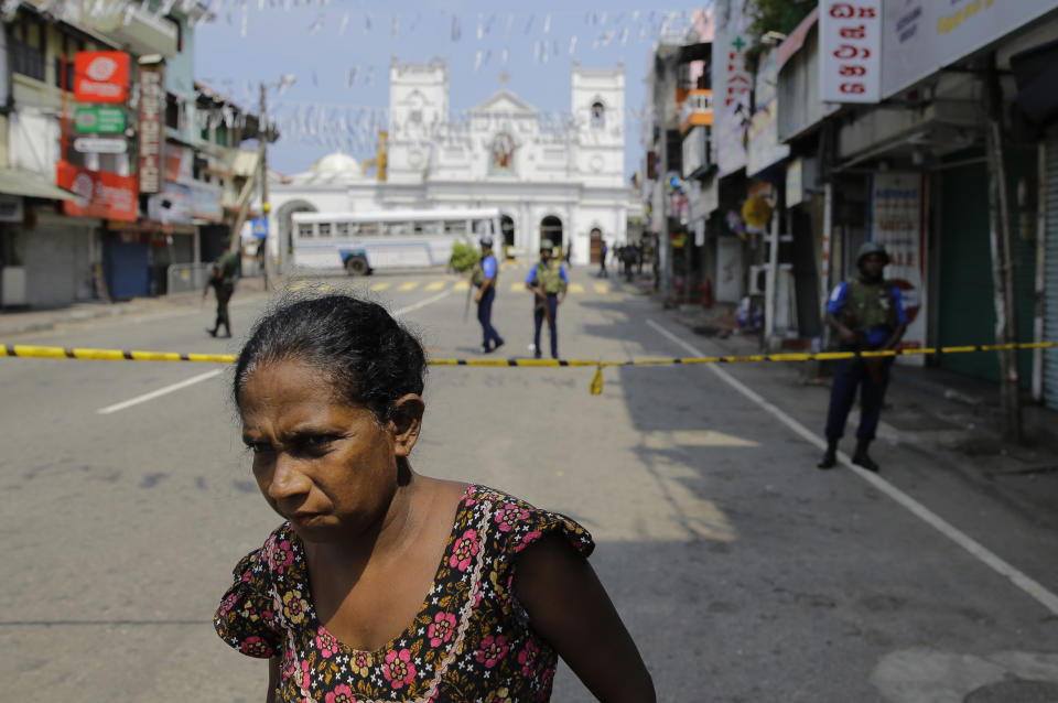 A Sri Lankan ethnic Tamil woman walks on a road leading to St. Anthony's Church, one of the sites of Easter Sunday's bomb attacks in Colombo, Sri Lanka, Thursday, April 25, 2019. Christians in Sri Lanka belong to both its main ethnic groups, and that rare inclusiveness of a small religious minority may explain the measured calm that’s been the response so far to the Easter attacks. But there’s widespread fear that more attacks could plunge Sri Lanka into the cycle of violence and retaliation that marked the bloody civil war that ended a decade ago. (AP Photo/Eranga Jayawardena)