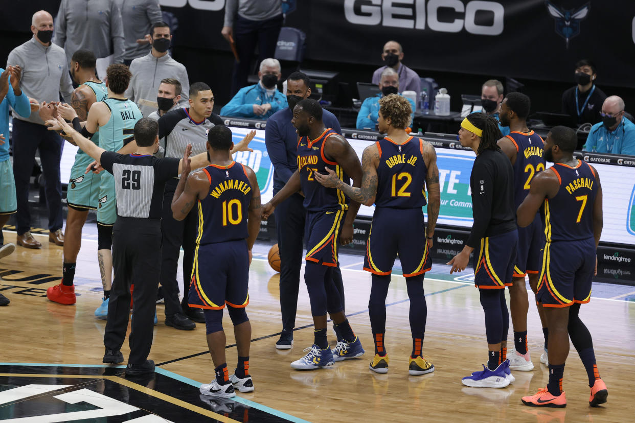 Draymond Green of the Golden State Warriors is held back while yelling at an official in Charlotte