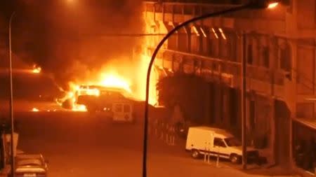 A view shows vehicles on fire outside Splendid Hotel in Ouagadougou, Burkina Faso in this still image taken from a video January 15, 2016, during a siege by Islamist gunmen. REUTERS/Reuters TV