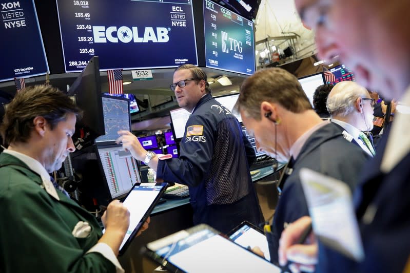 Traders work on the floor at the NYSE in New York