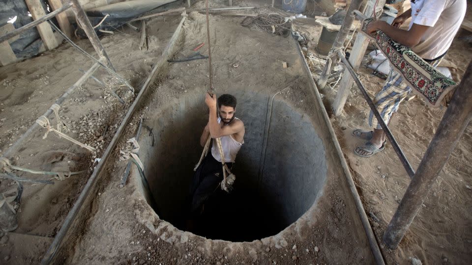 A Palestinian man is lowered into a smuggling tunnel beneath the Gaza-Egypt border, in the southern Gaza Strip, on September 11, 2013.  - Mahmud Hams/AFP/Getty Images/FILE