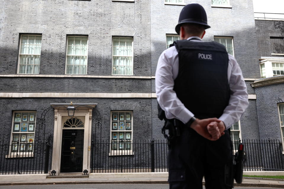 A police officer stands outside Number 10 Downing Street in London, Britain, April 12, 2022. REUTERS/Henry Nicholls