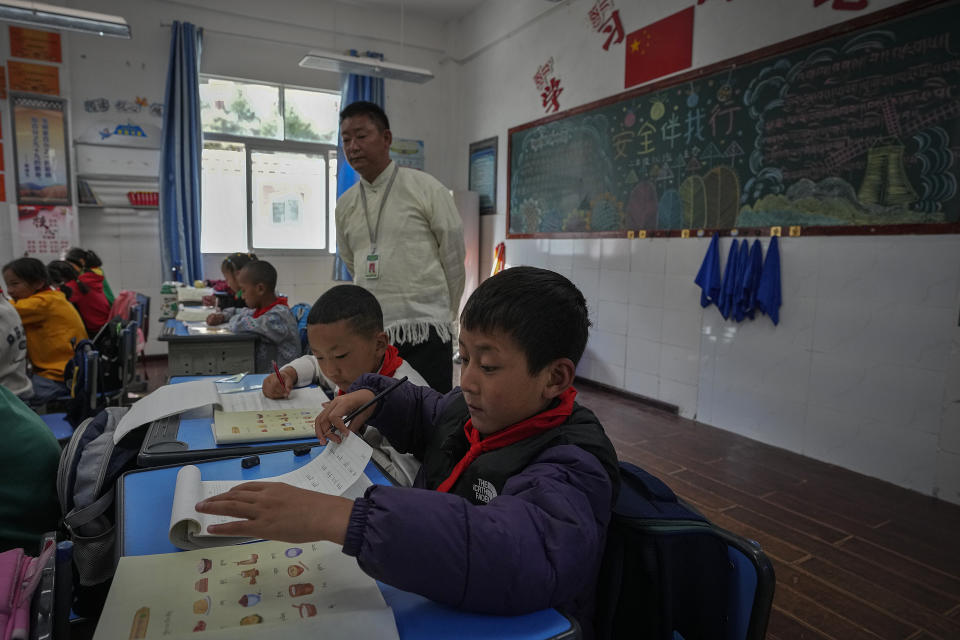 Tibetan students learn Tibetan writing in a first-grade class at the Shangri-La Key Boarding School during a media-organized tour in Dabpa county, Kardze Prefecture, Sichuan province, China on Sept. 5, 2023. (AP Photo/Andy Wong)