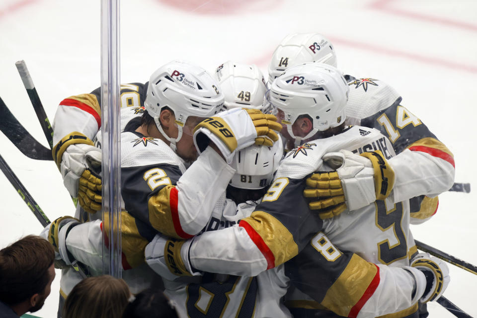 CORRECTS TO RIGHT WING JONATHAN MARCHESSAULT SCORED NOT IVAN BARBASHEV - Vegas Golden Knights players celebrate together after right wing Jonathan Marchessault scored during the second period of Game 6 of the NHL hockey Stanley Cup Western Conference finals against the Dallas Stars, Monday, May 29, 2023, in Dallas. (AP Photo/Gareth Patterson)