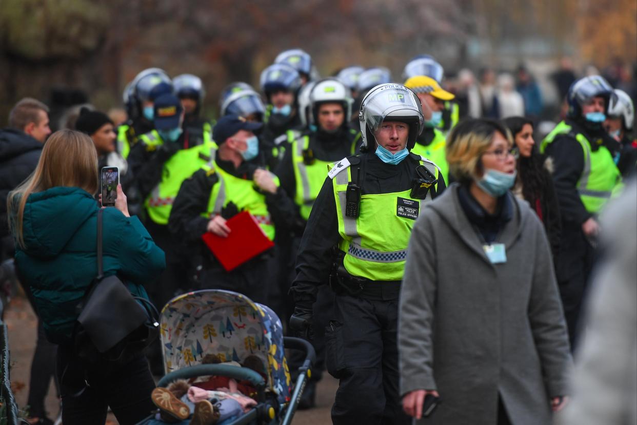 Police officers in riot gear are seen walk through St James’ Park in London (Getty Images)