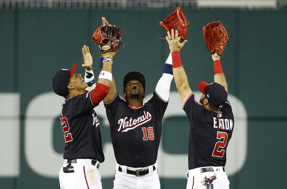 FILE - In this June 4, 2019, file photo, Washington Nationals outfielders Juan Soto, from left, Victor Robles and Adam Eaton celebrate after beating the Chicago White Sox 9-5 in an interleague baseball game in Washington. For the 2019 Nationals, Game No. 60 on June 4, 2019, served as something of a microcosm of the whole season and an example of their "Stay in the fight" mindset instilled by manager Dave Martinez. (AP Photo/Patrick Semansky, File)