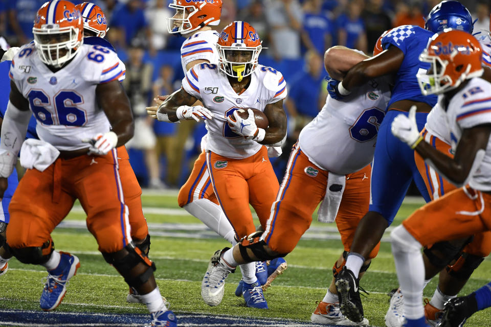 Florida running back Lamical Perine (2) attempts to break through an opening in the Kentucky defensive line during the second half of an NCAA college football game in Lexington, Ky., Saturday, Sept. 14, 2019. (AP Photo/Timothy D. Easley)