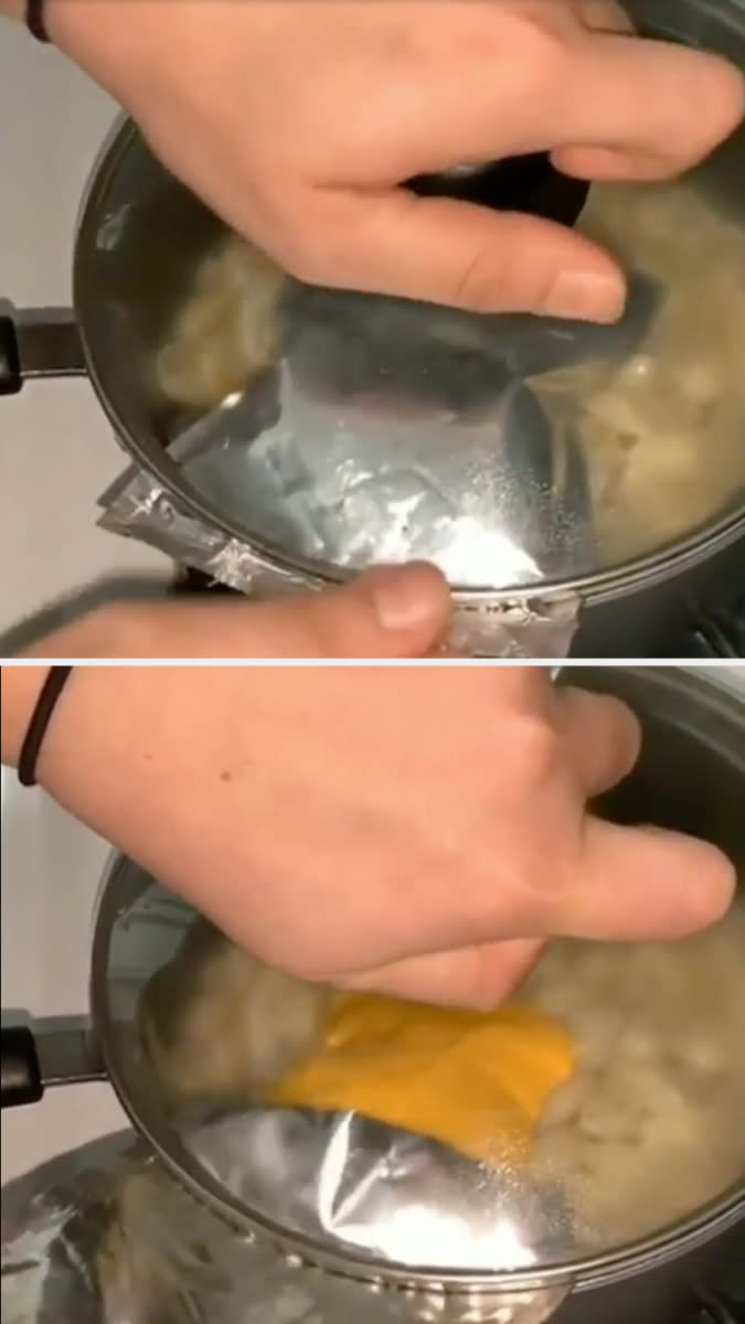 cheese packet pressed against a pot lid to squeeze out all the contents