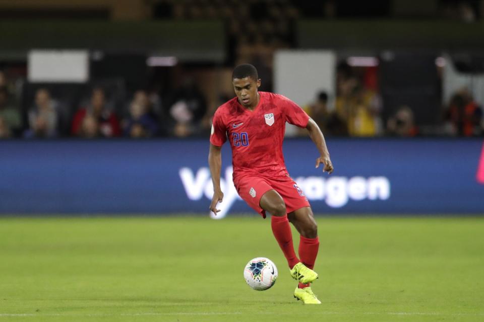 The United States' Reggie Cannon dribbles the ball