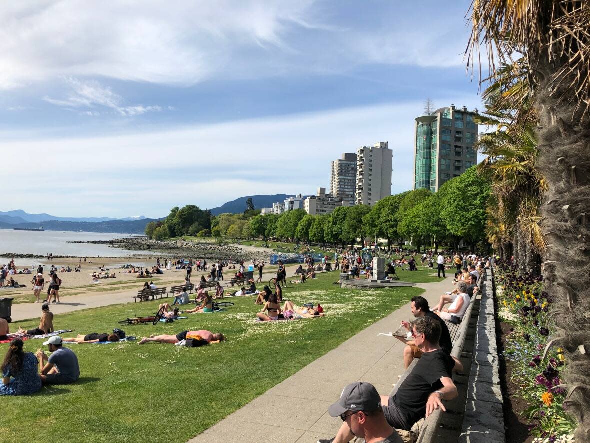 People sit in the sun in Vancouver's English Bay, on May 10, 2020. (Meghan McMenamie - image credit)