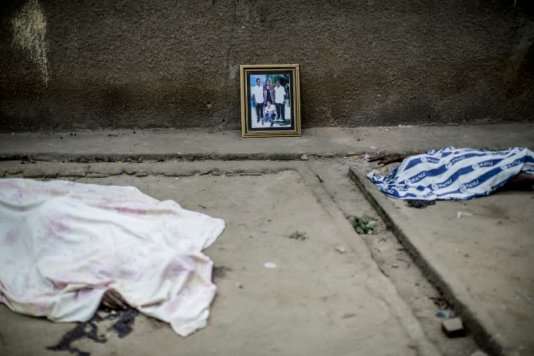 A family portrait is placed on July 2, 2015 next to the bodies of some of the victims of the unrest that rocked the neighbourhood of Mutakura in Bujumbura the day before, when at least six people were killed during clashes with police