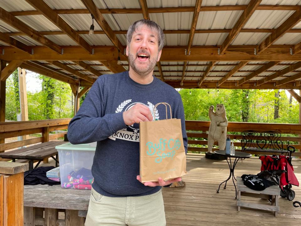 Jacob Davis, director of Knox Pride Podcast, checks out a prize bag of goodies at the Knox Pride Bingo event at Hey Bear Café Tuesday, April 23, 2024.