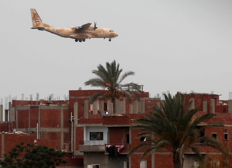 FILE PHOTO: An Egyptian military plane flies overs houses in Abu Kabir, Sharqia Governorate, north of Cairo