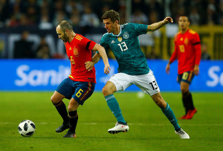 Soccer Football - International Friendly - Germany vs Spain - ESPRIT arena, Dusseldorf, Germany - March 23, 2018 Spain’s Andres Iniesta in action with Germany’s Thomas Mueller REUTERS/Thilo Schmuelgen