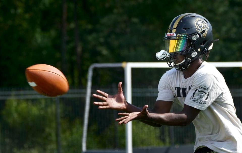 A.J. Parry of North Kingstown pulls in a ball during a passing drill on the first day of football practice in August.