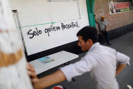 Central American migrants, moving in a caravan through Mexico and traveling to request asylum in U.S, are pictured as they arrive in Mexicali, Baja California state, Mexico April 25, 2018. The words read, "I just want Rock and Roll". REUTERS/Edgard Garrido