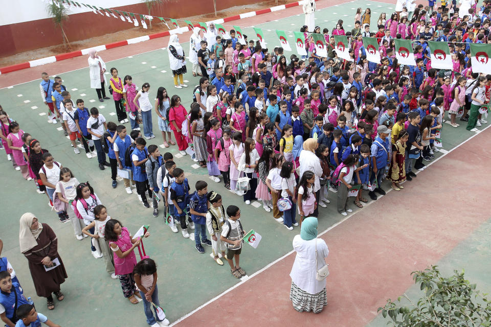 FILE - Schoolchildren wait in line in a school courtyard in the Ben Omar district of Algiers, Algeria, on Sept. 19, 2023. More than a year after Algeria launched a pilot program to teach English in elementary schools, the country is hailing it as a success and expanding it in a move that reflects a widening linguistic shift underway in former French colonies throughout Africa. (AP Photo, File)