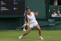 China's Yuan Yue plays a return to Victoria Azarenka of Belarus during the first round women's singles match on day one of the Wimbledon tennis championships in London, Monday, July 3, 2023. (AP Photo/Alastair Grant)